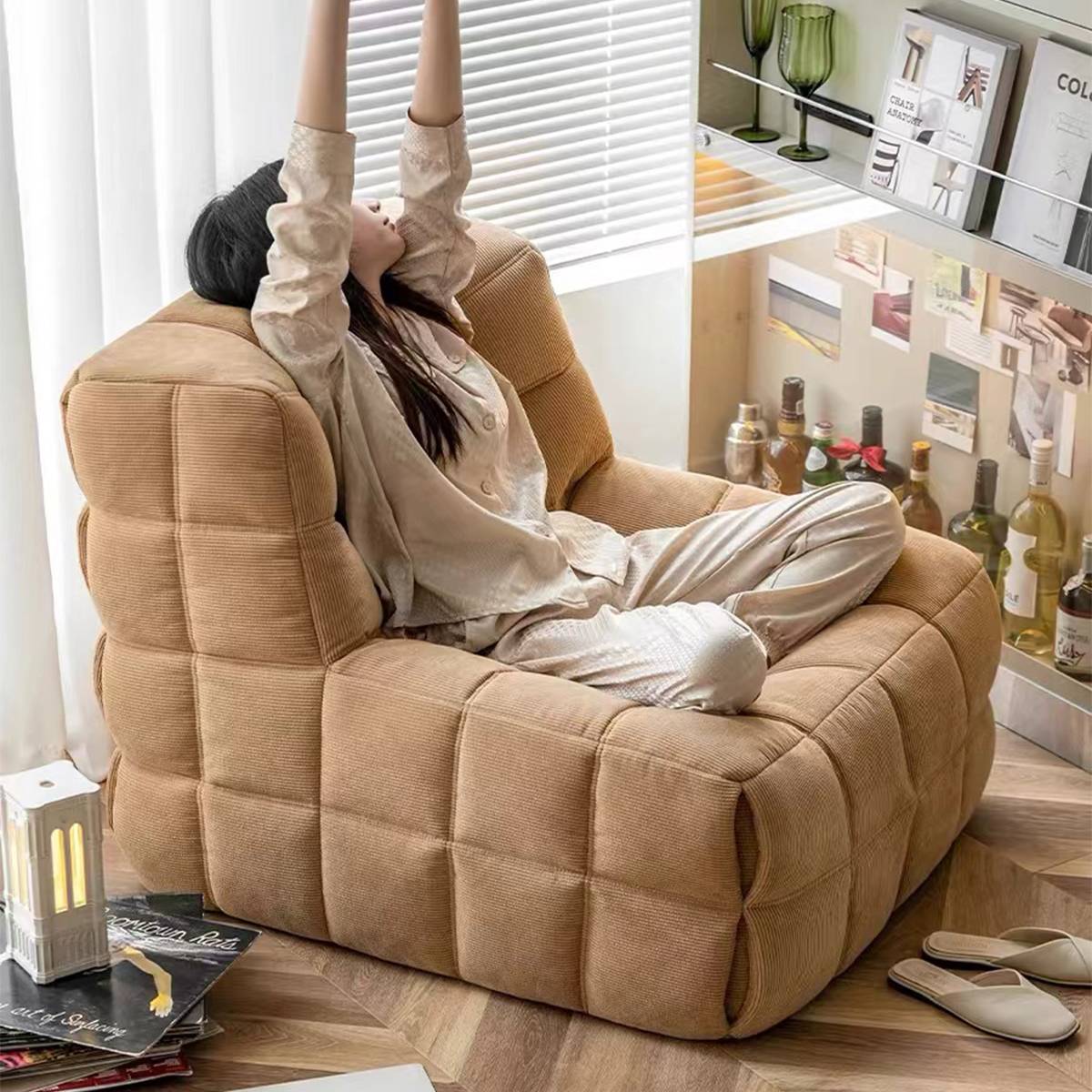 Person relaxing in a beige waffle grid lounge chair