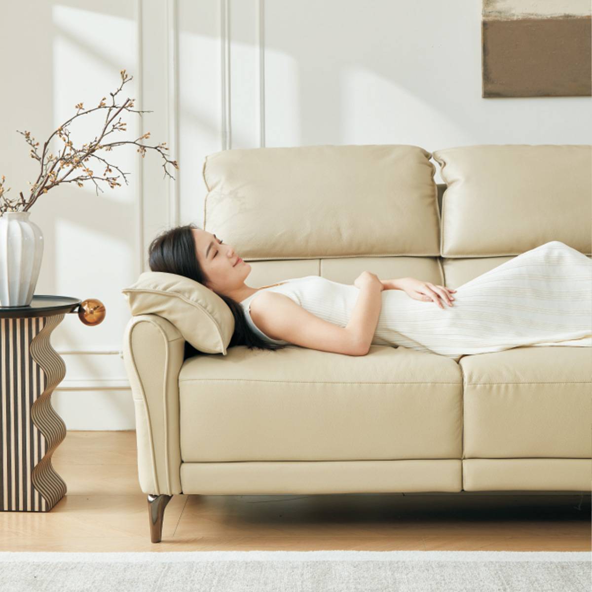 Woman lying down on the sofa for a nap