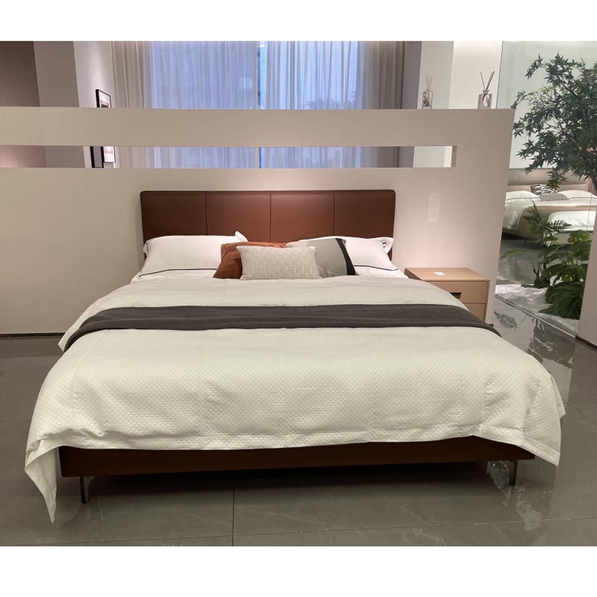Front view of the bed with grey throw and white duvet
