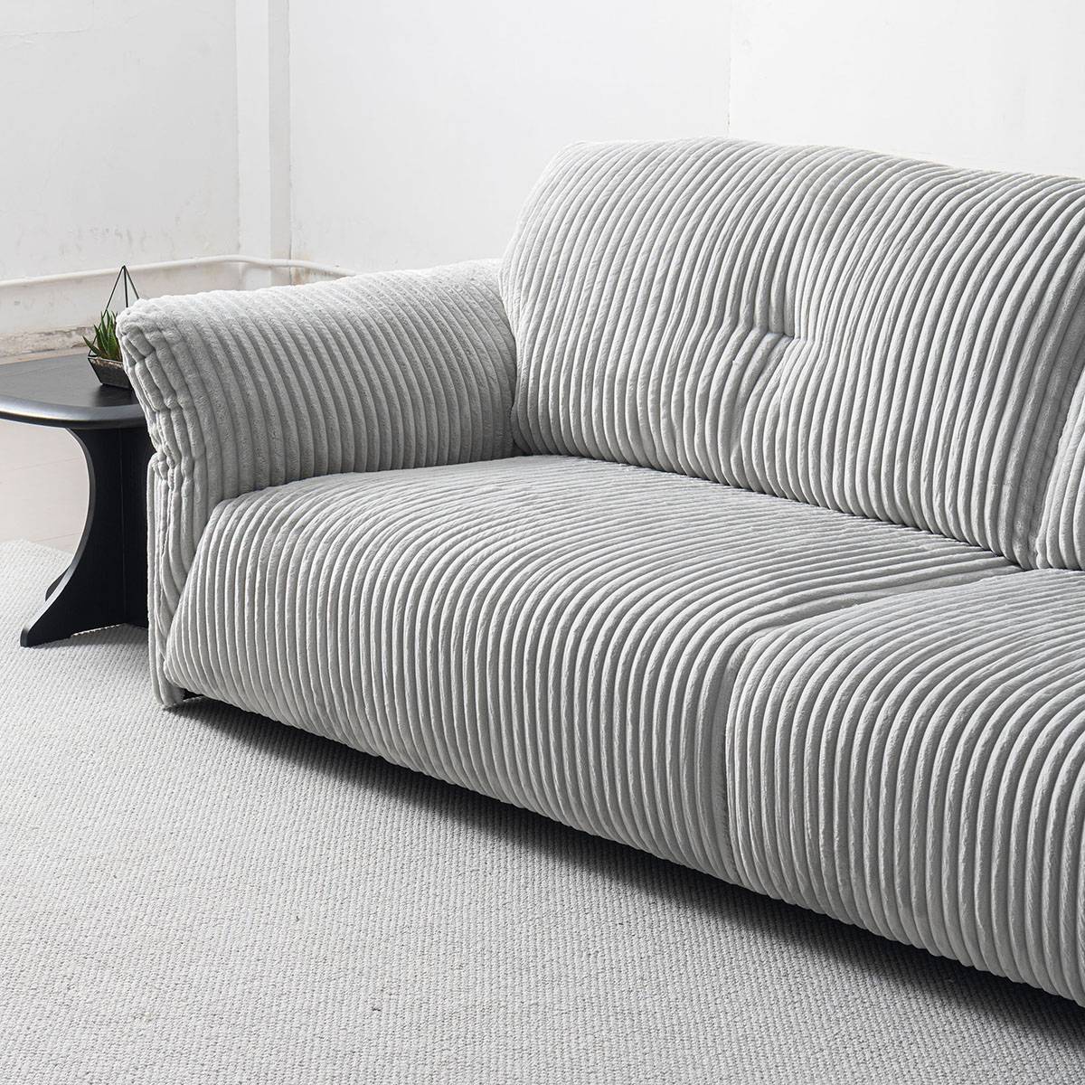 Side angle view of the sofa highlighting the seat cushions and backrest