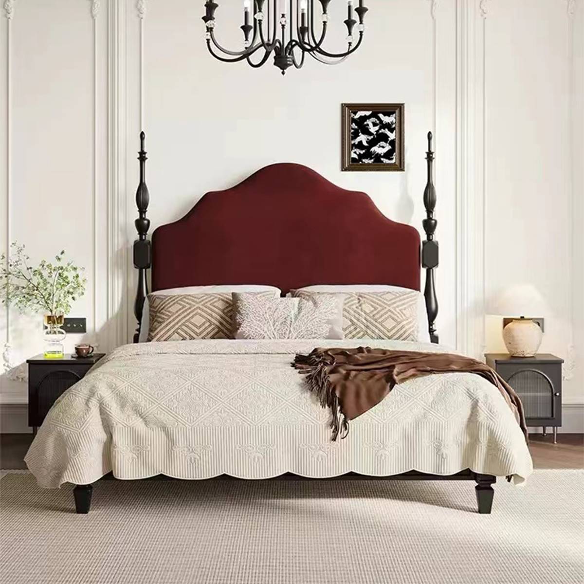Bedroom setting showing the bed with bedside tables and chandelier