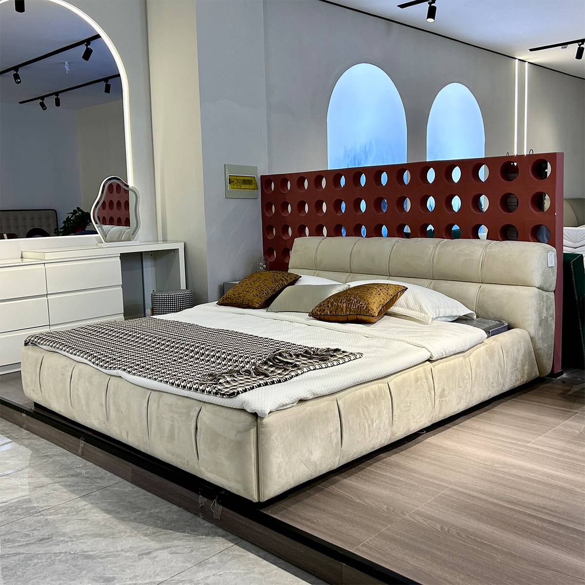 View of the bed highlighting the headboard and surrounding decor