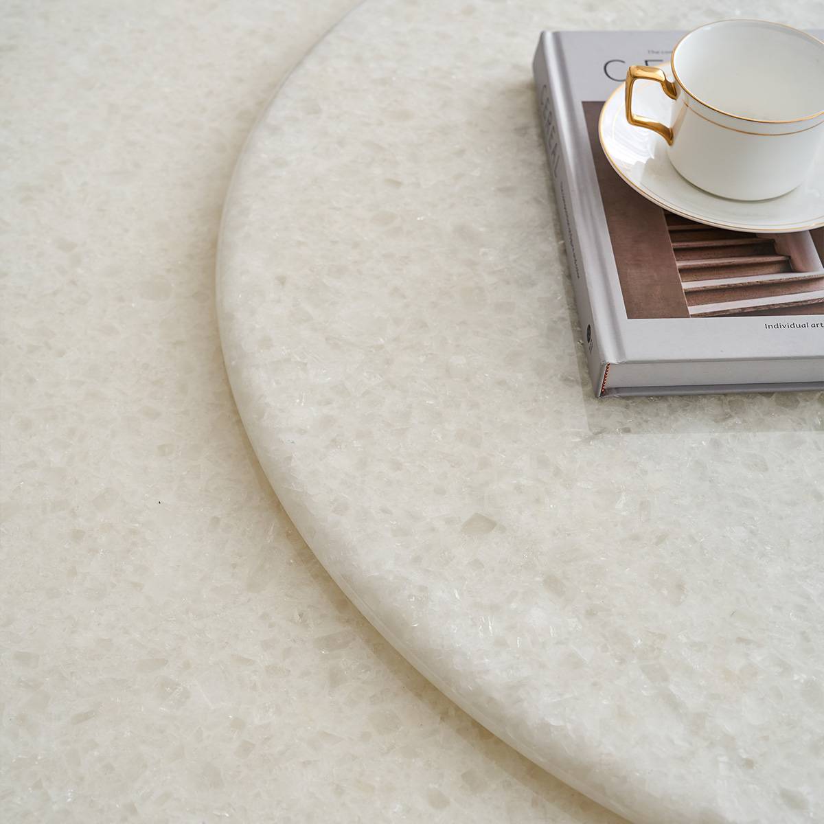Close-up detail of the Brazilian Ice Diamond natural stone texture on the round dining table surface
