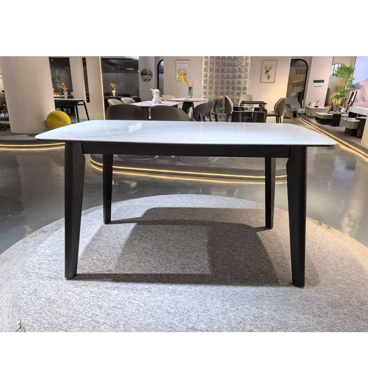 Front view of the marble dining table in a showroom setting