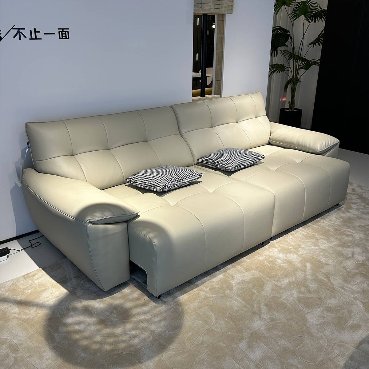 Opposite angle view of the beige sofa bed highlighting the backrest and seat depth
