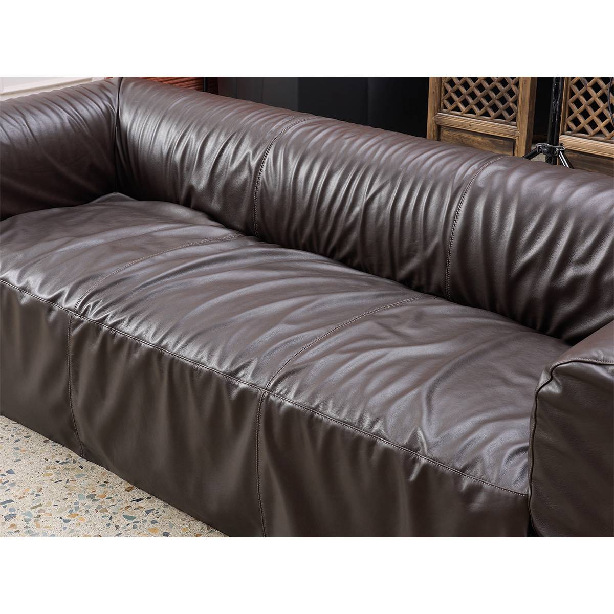 Close-up view of the brown oil wax cowhide leather texture on the sofa seat and backrest