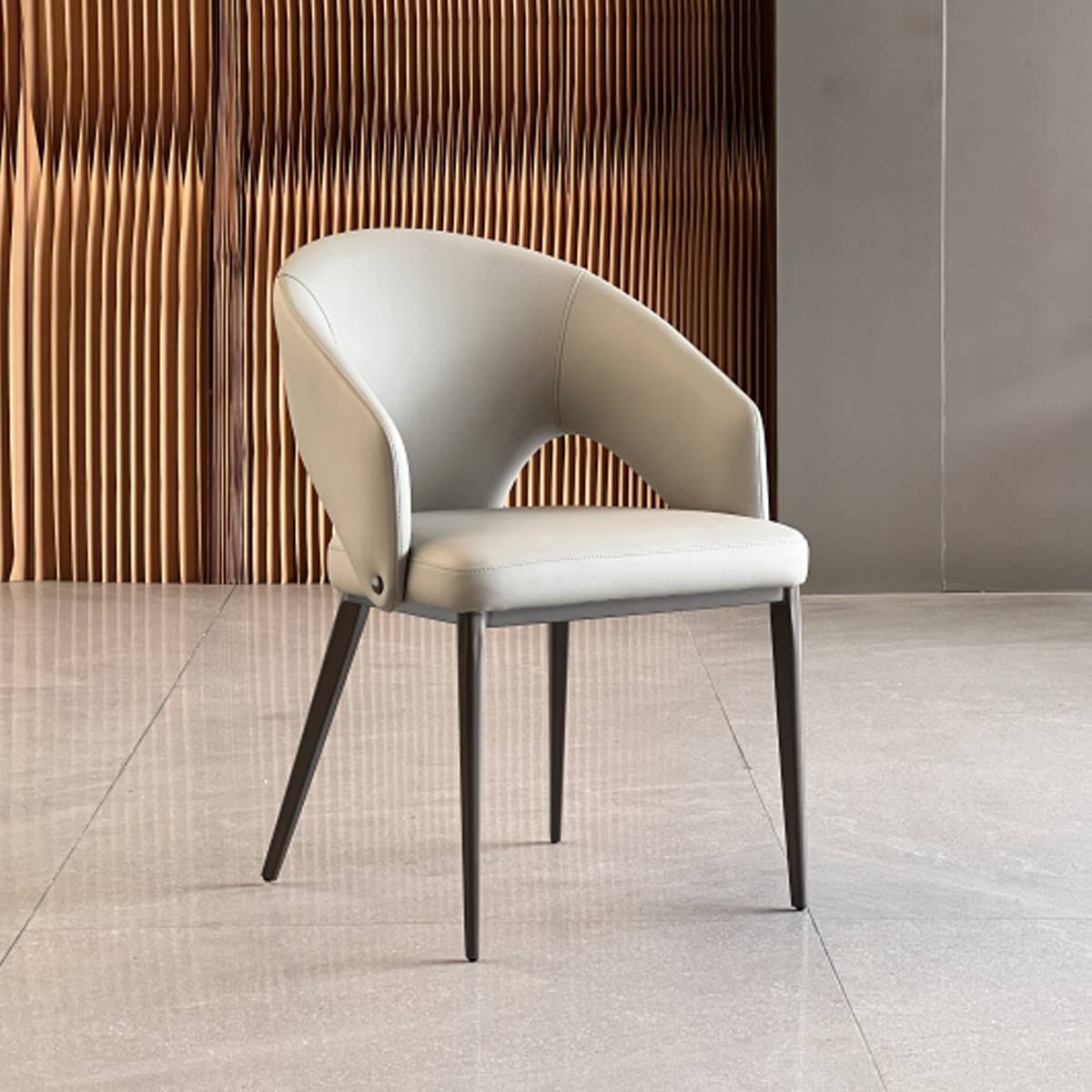 Side profile view of the beige dining chair showing the curved backrest