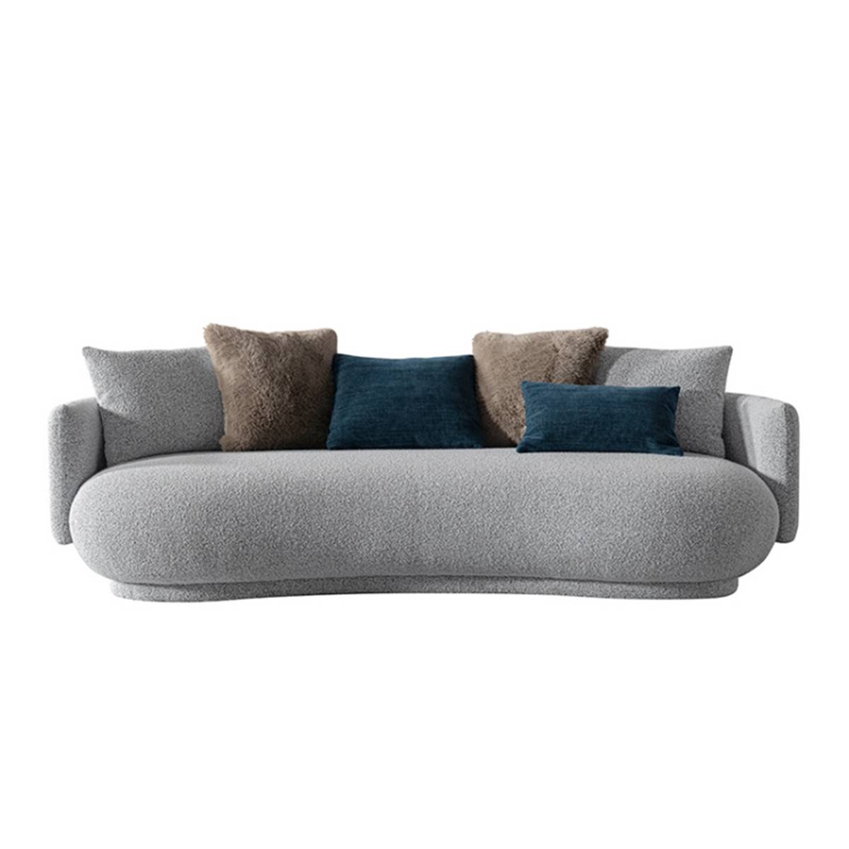Front view of a grey curved fabric sofa with brown and blue throw pillows