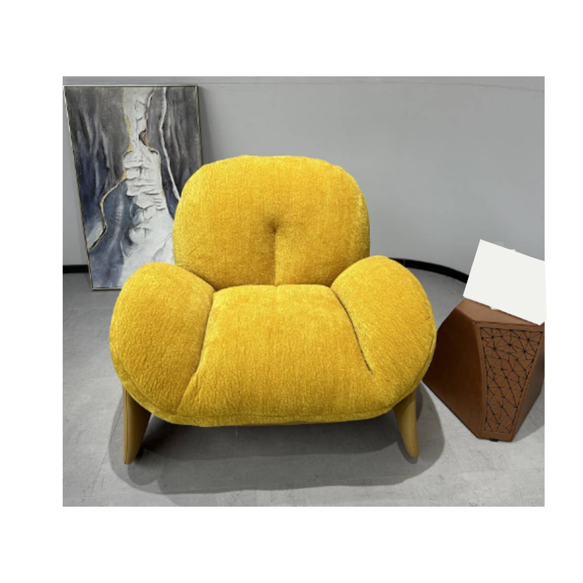 Front view of a yellow boucle lounge chair with wooden legs