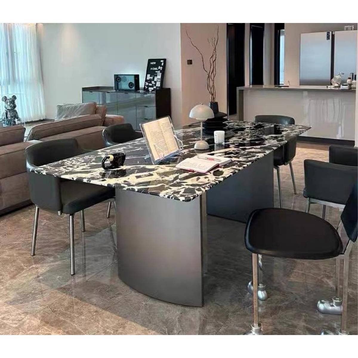 Side view of the dining table showing the curved stainless steel base and stone top texture