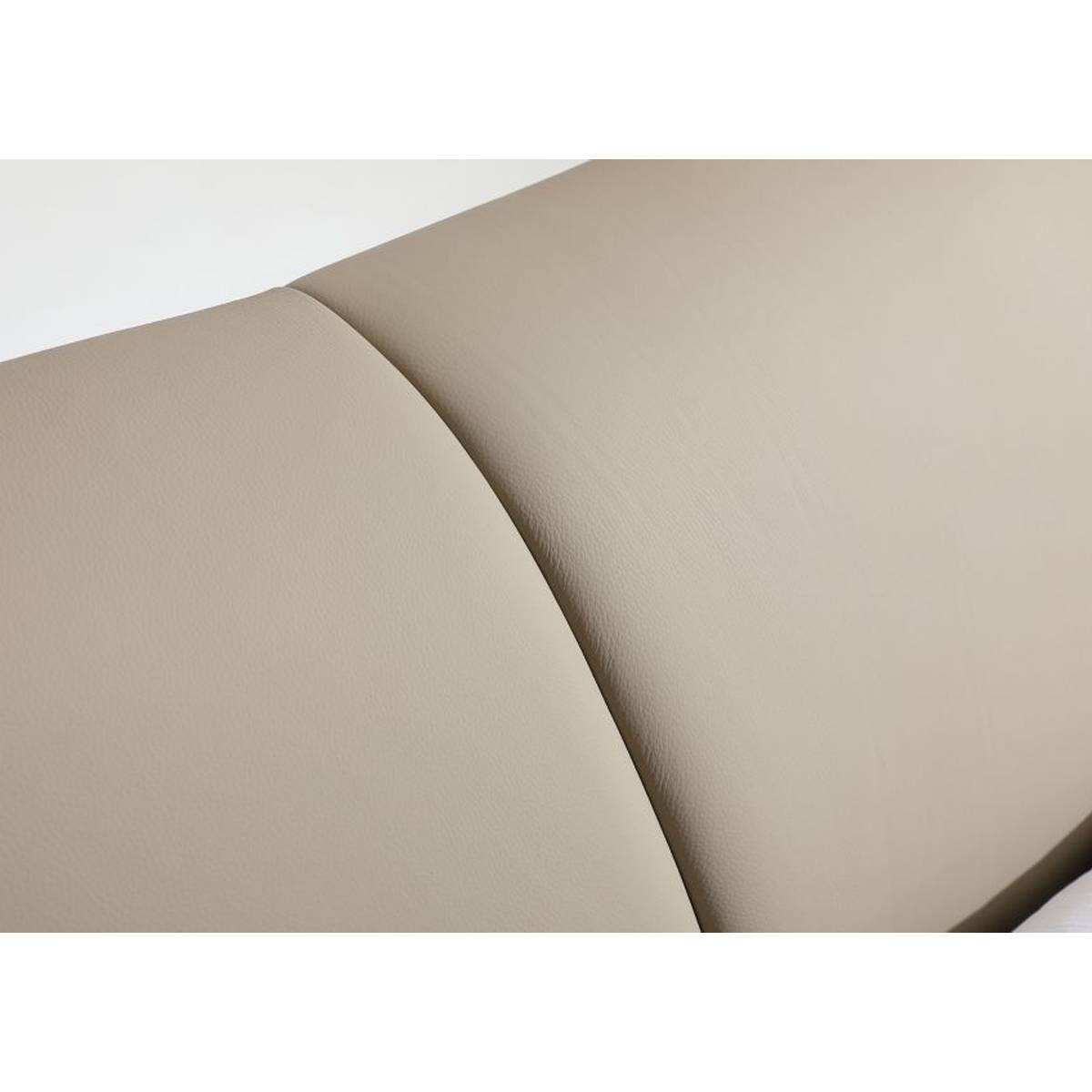 Close-up detail of the beige leather headboard texture and stitching