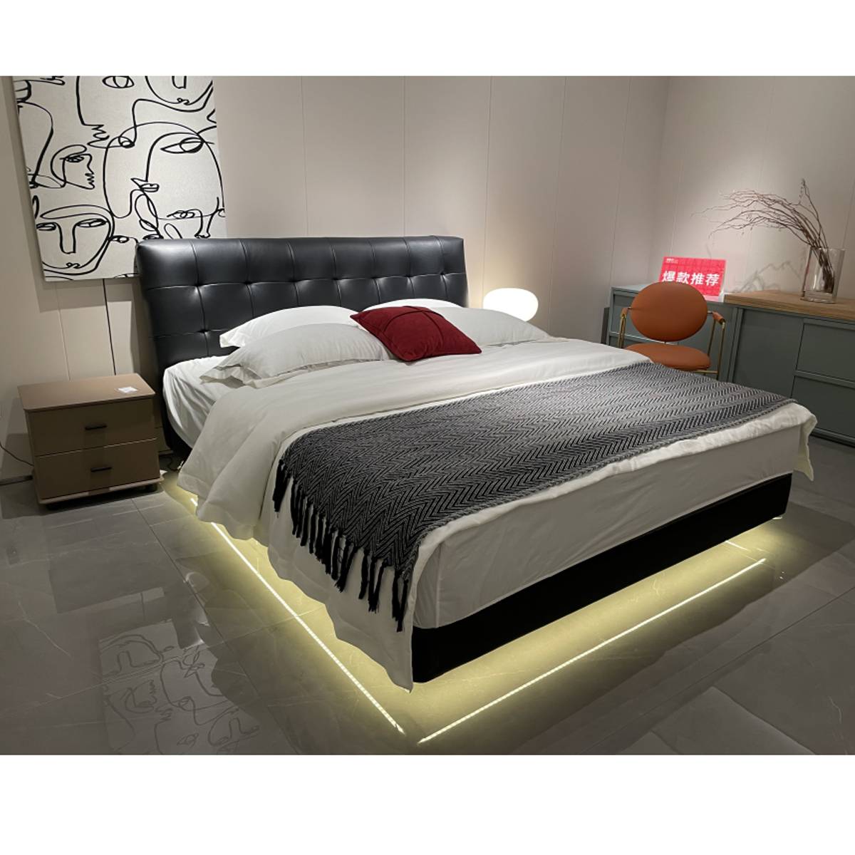 Front angled view of the bed showing the tufted headboard and bedding