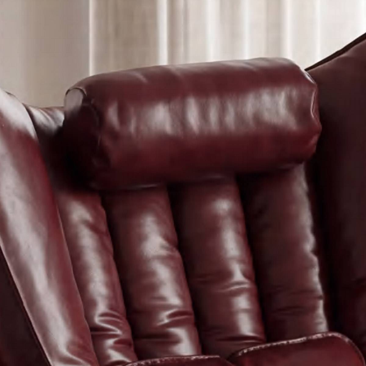 Close-up of the tufted leather backrest and headrest cushion