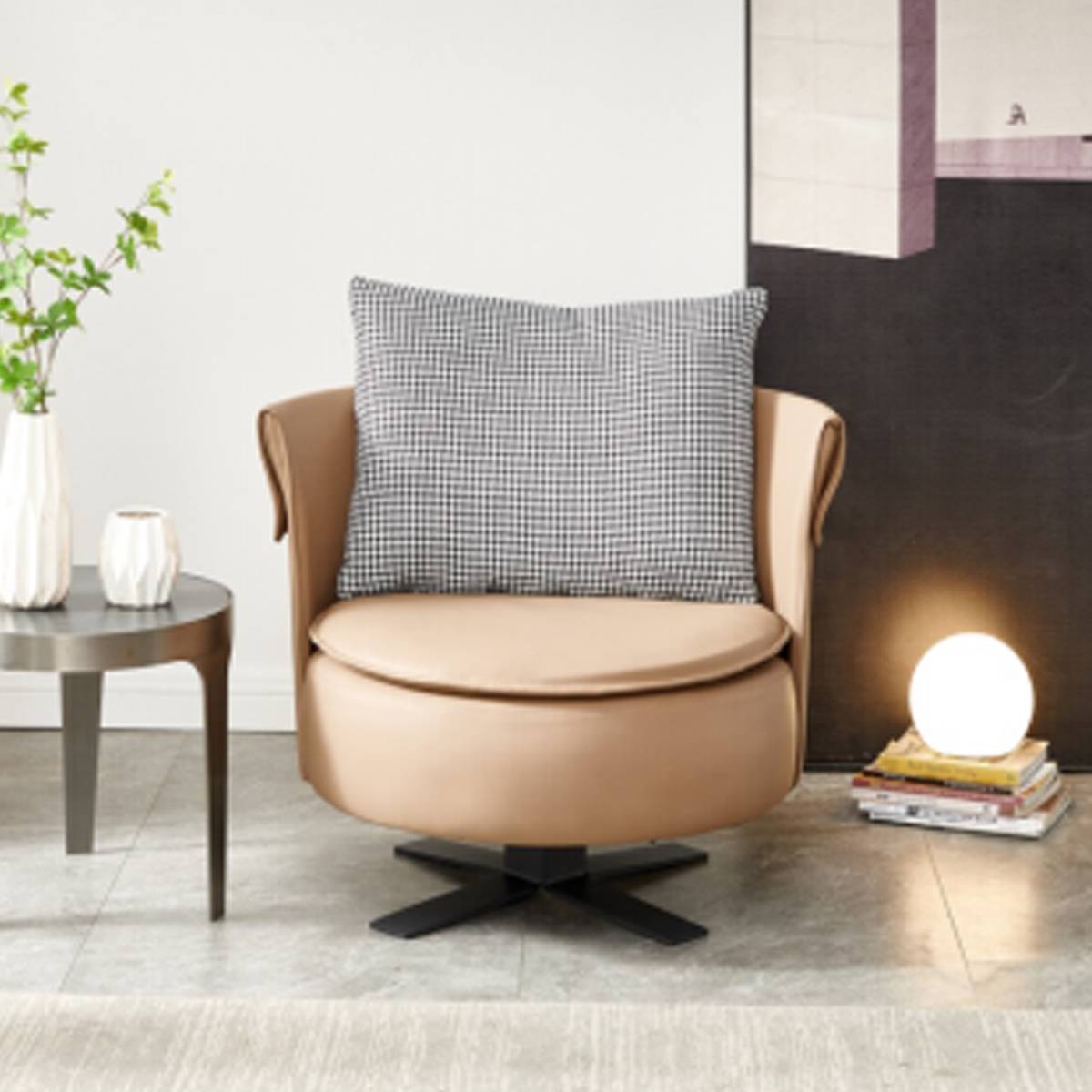 Front view of a tan leather swivel lounge chair with a checkered pillow, highlighting the curved design and metal base.