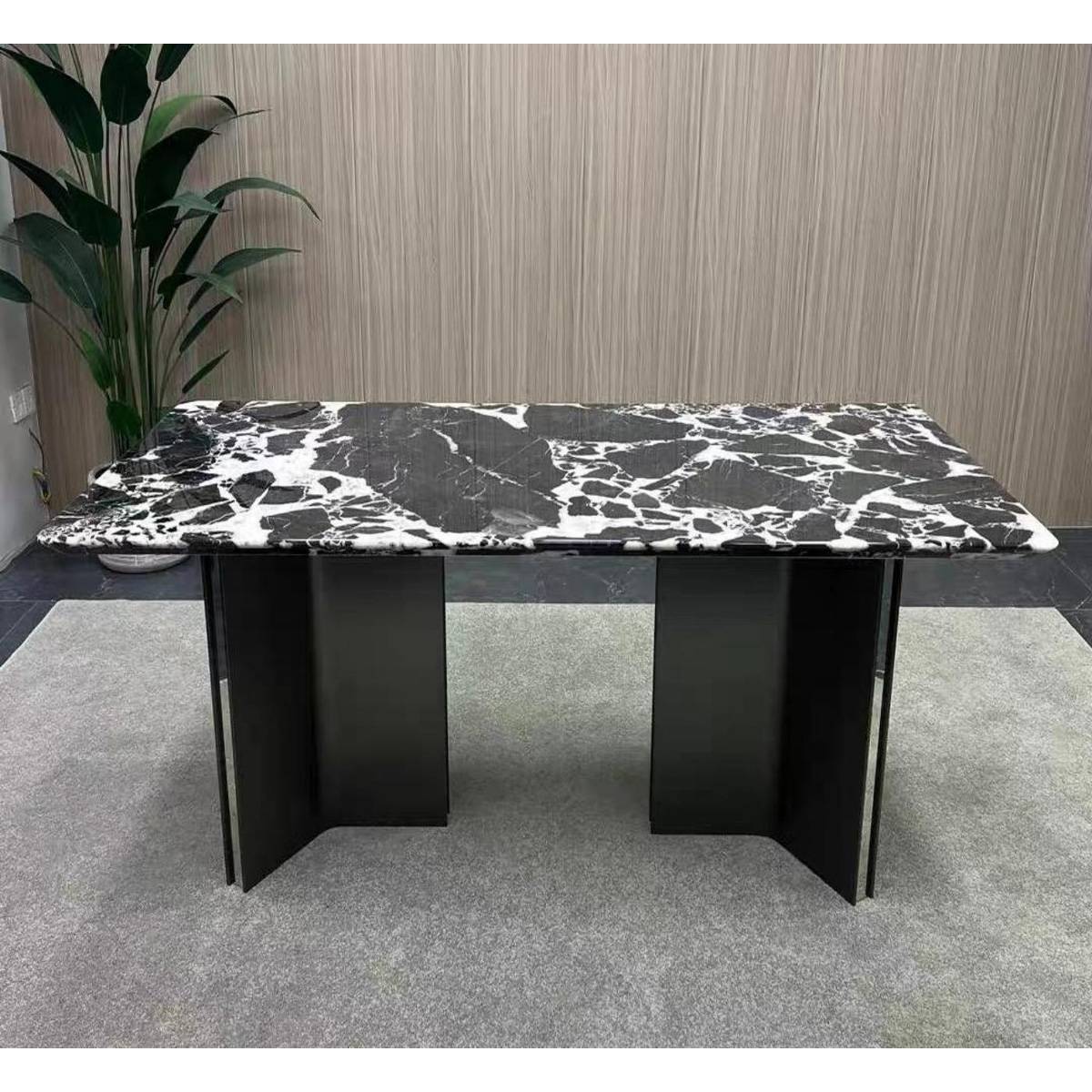 Front view of the marble dining table showing the stainless steel Mercedes base