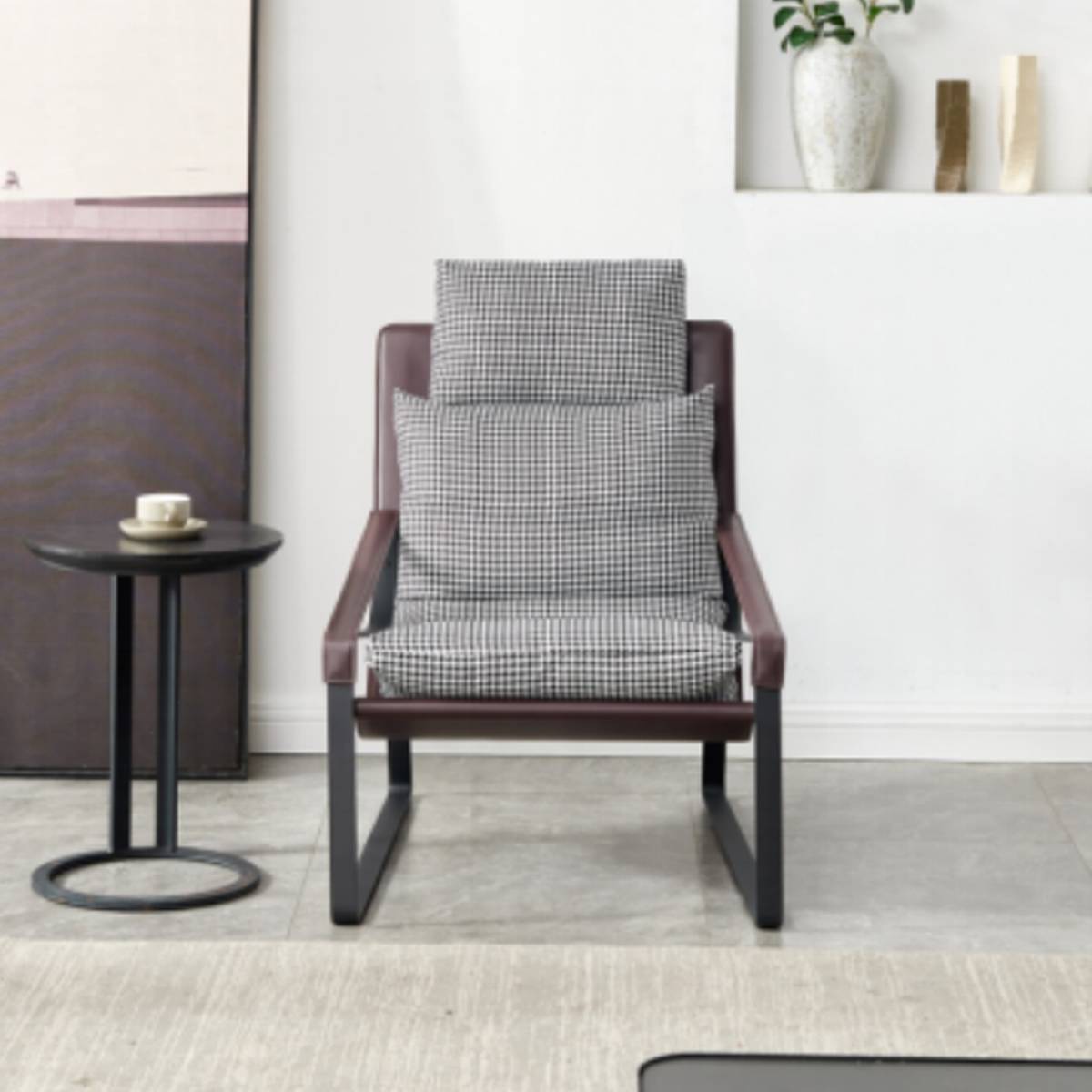 Front view of the lounge chair showing the houndstooth pattern and iron frame