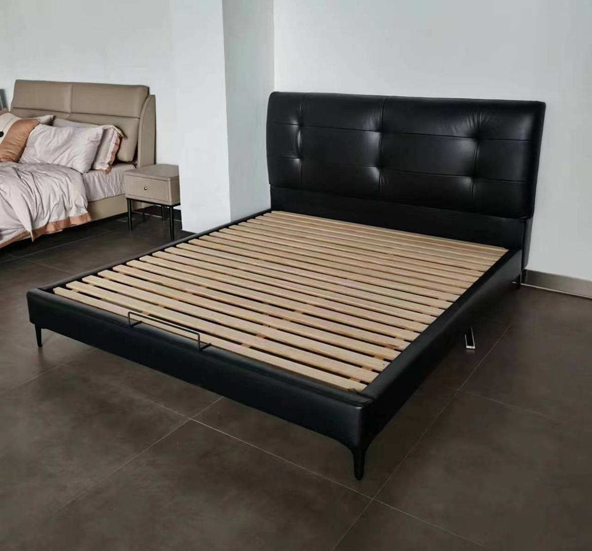 Side angle view of the black leather bed frame