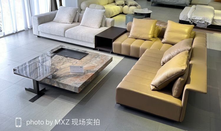 Full view of the beige piano key sofa in a showroom setting
