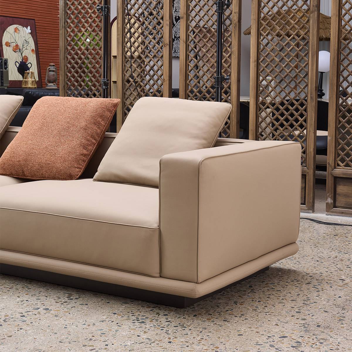 Close-up view of the beige semi-leather sofa armrest and seat cushion, showing the texture and stitching details.