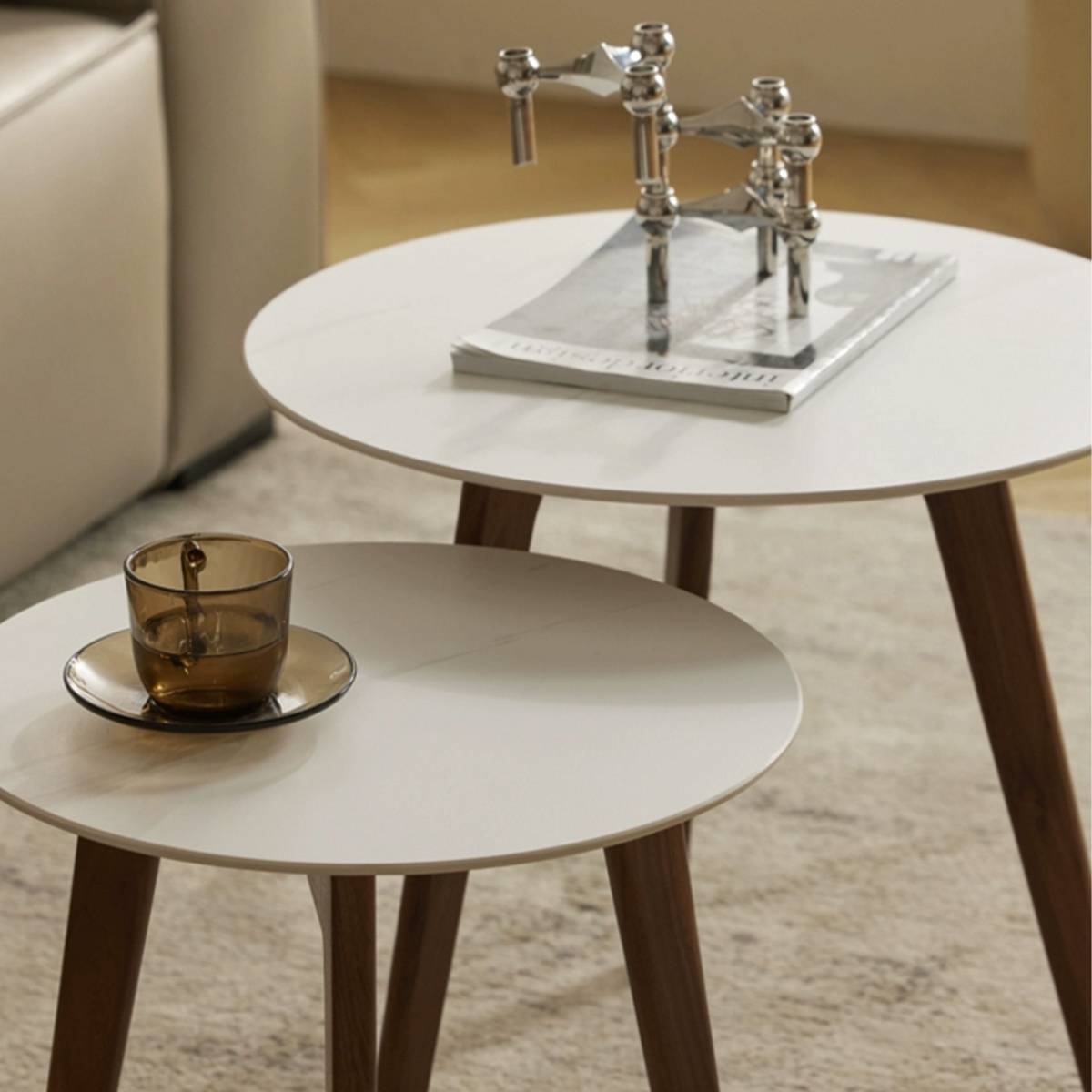 Close-up of the white sintered stone table surface with a magazine and candle holder