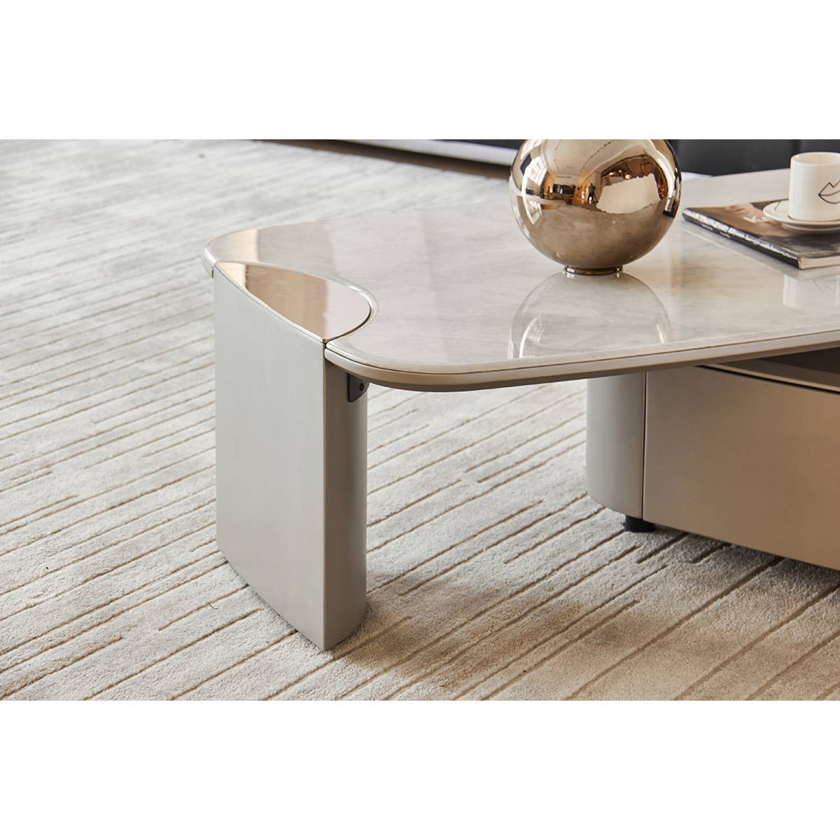 Close-up of the stainless steel leg and the edge of the microcrystalline stone tabletop.