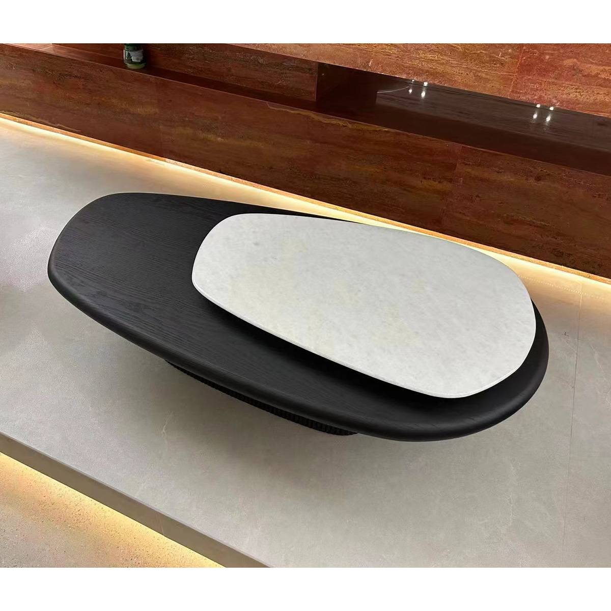Top-down view of a black and white rotating coffee table with a natural stone top