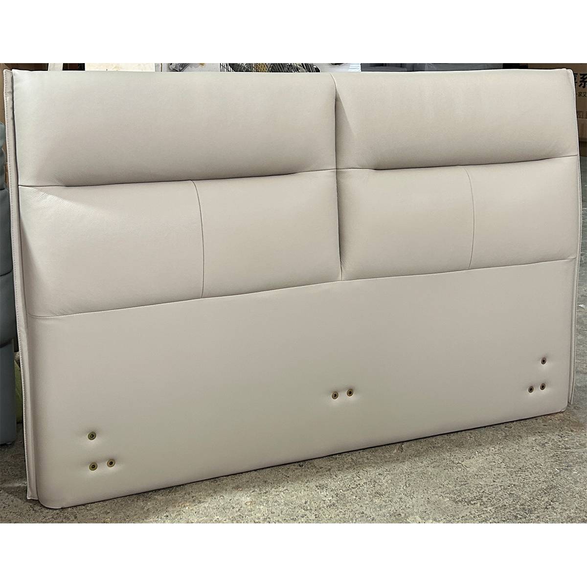 Close-up of the leather headboard showing stitching details and mounting holes