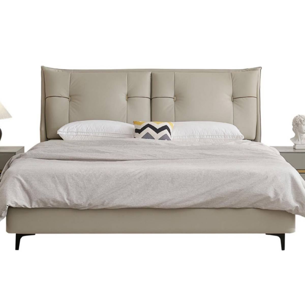 Front view of the bed with grey bedding and decorative pillow