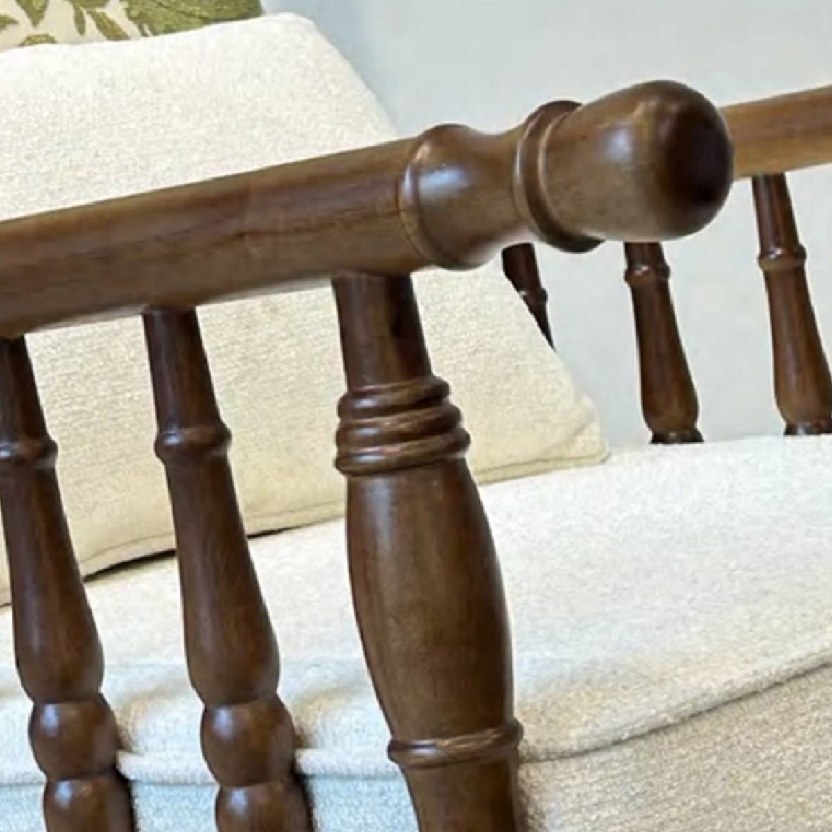 Close-up detail of the turned wooden spindles and armrest