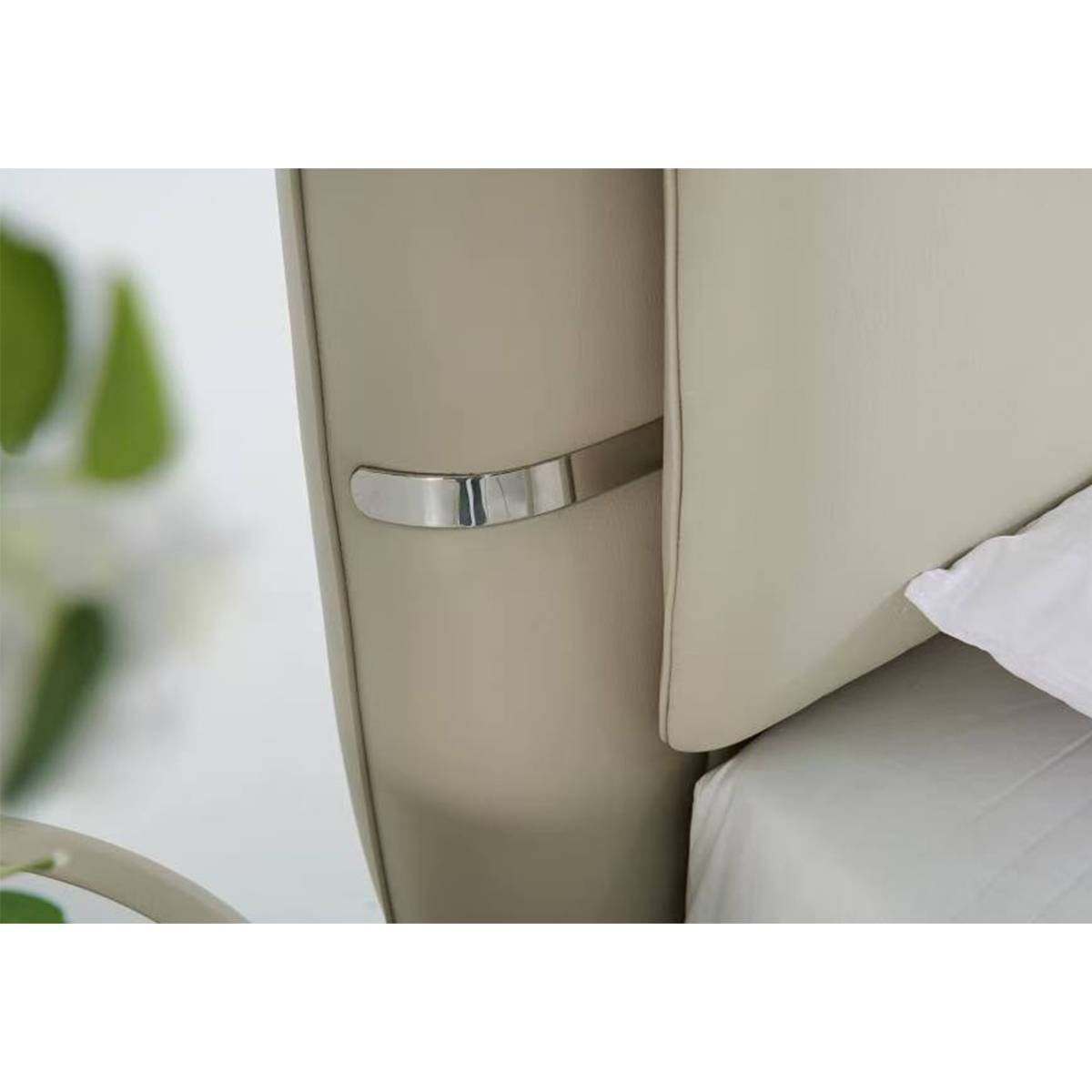 Close-up detail of the chrome metal accent on the headboard side