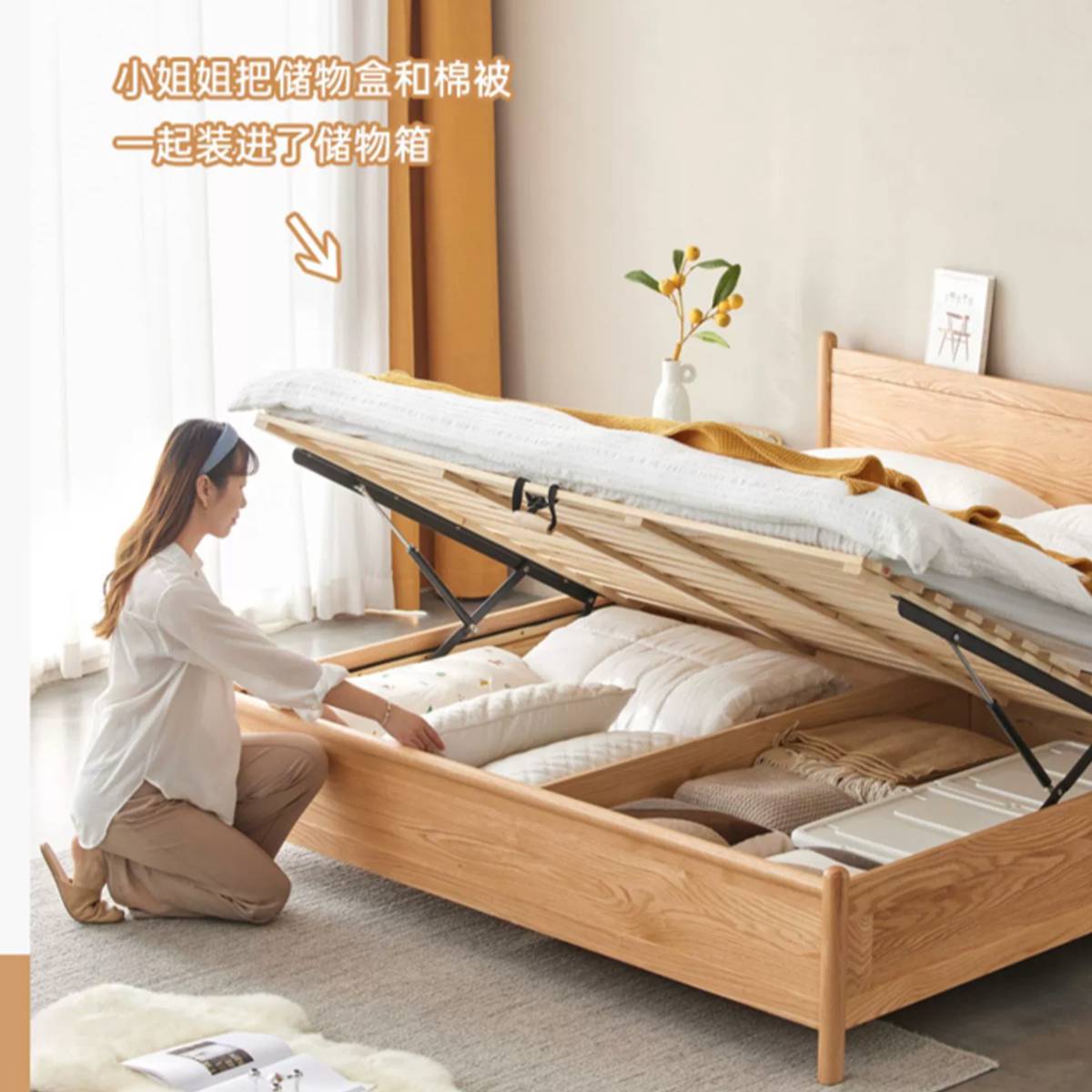 Woman kneeling beside the bed organizing bedding in the storage box