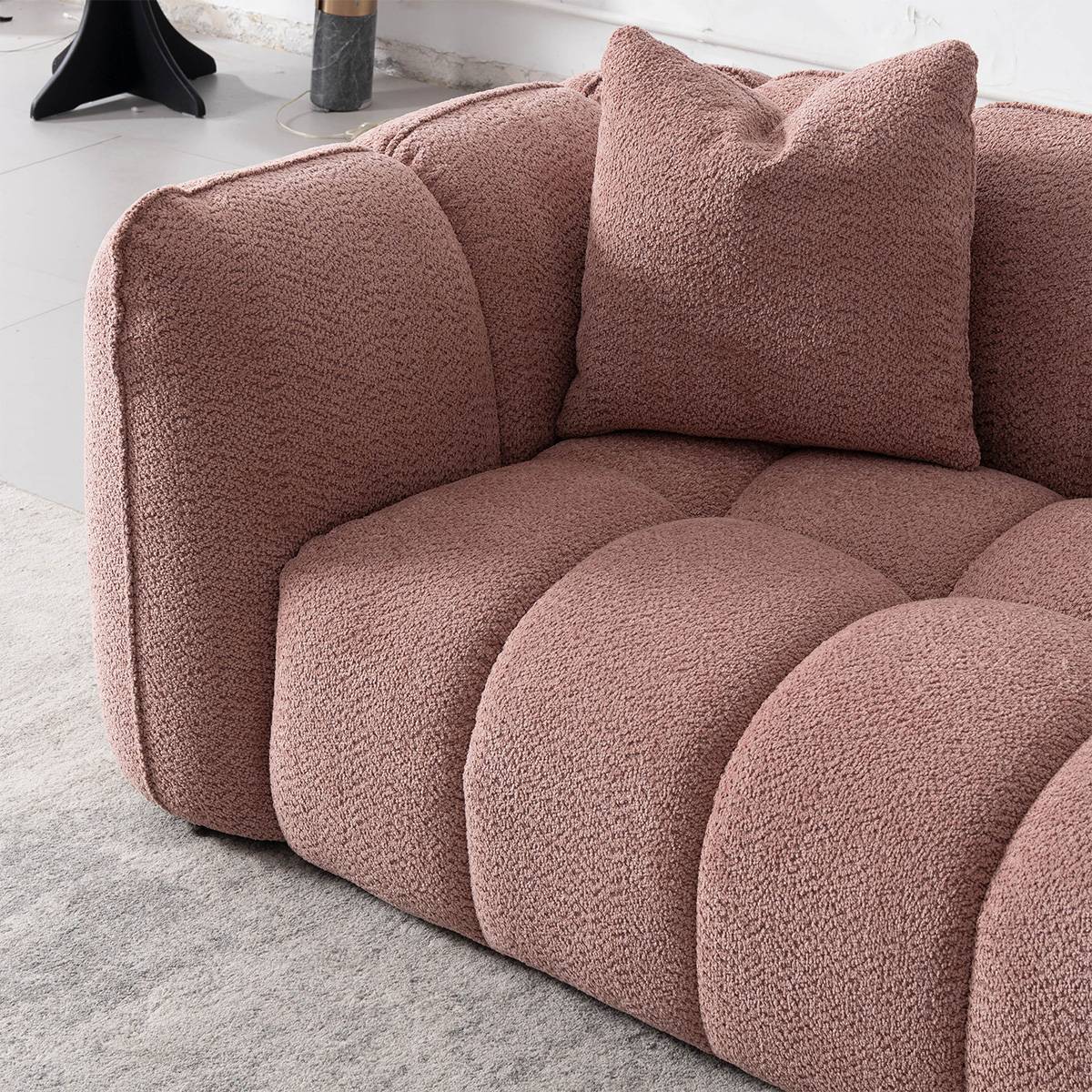 Close-up detail of the sofa fabric texture and armrest