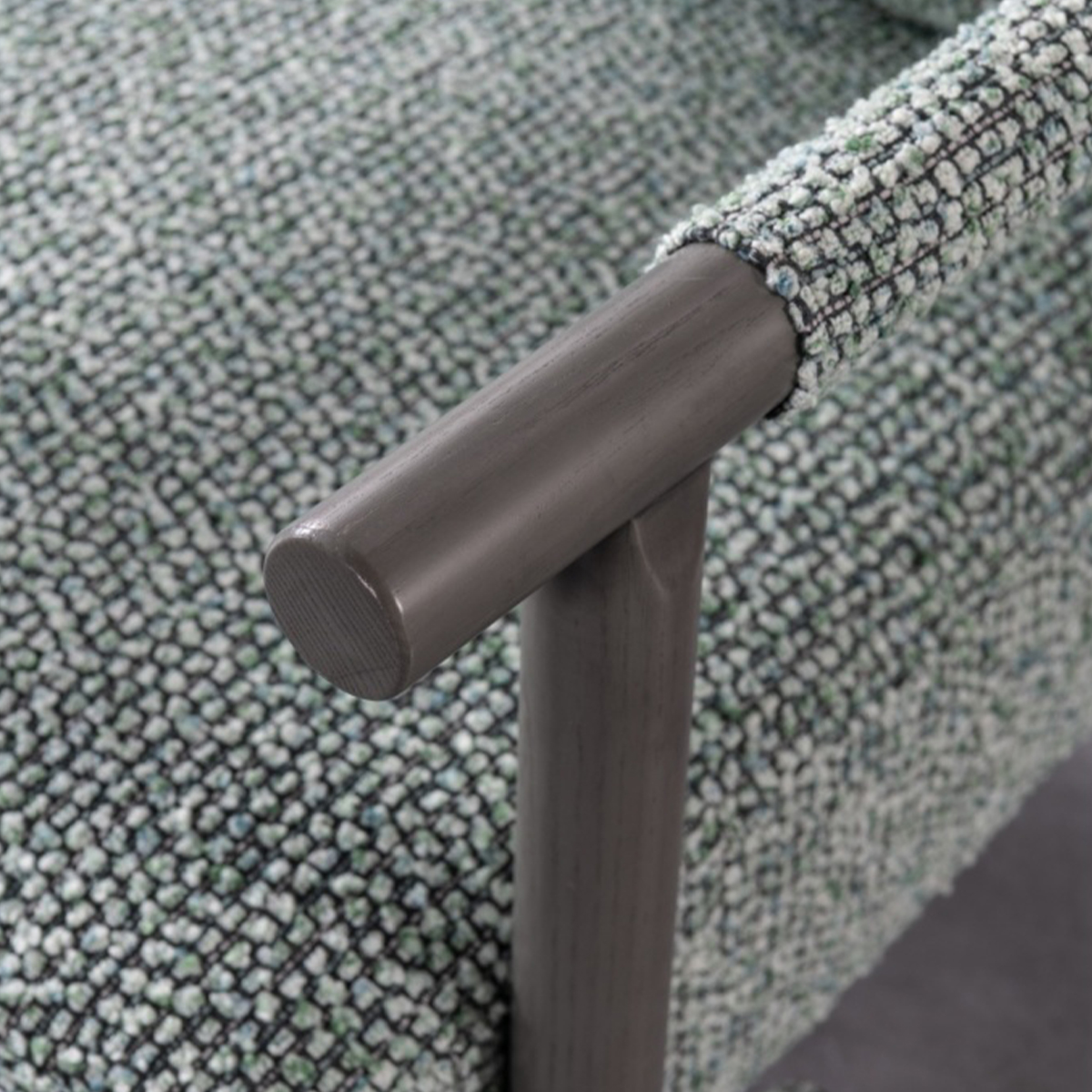 Rear view of the green fabric leisure chair showing the wooden frame structure