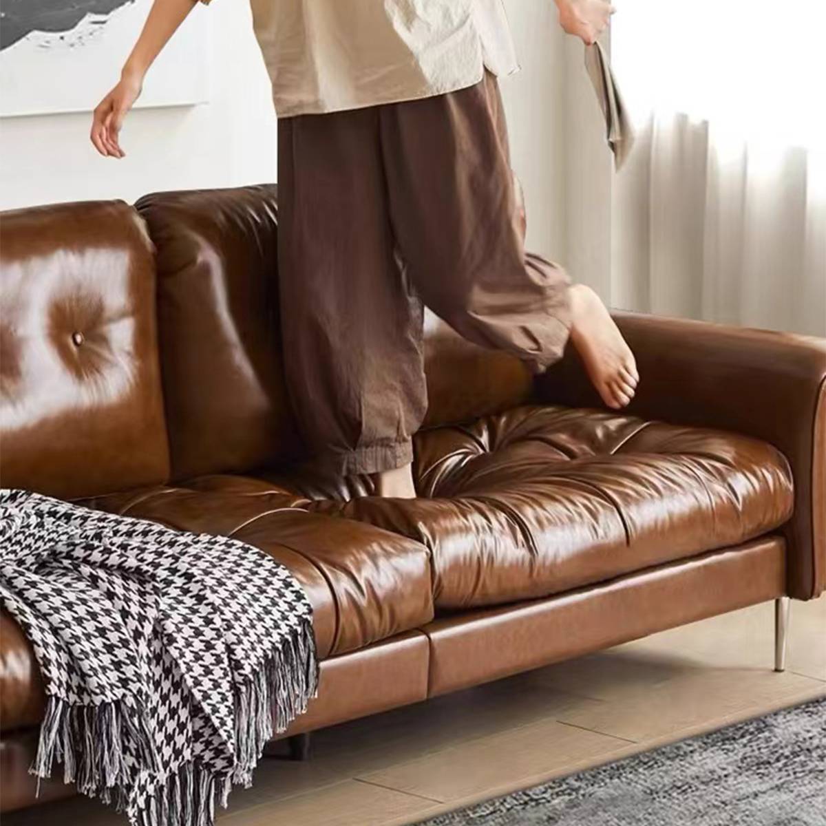 Person jumping on the sofa to demonstrate cushion resilience