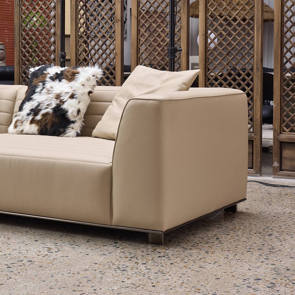 Close-up detail of the sofa armrest and leather texture