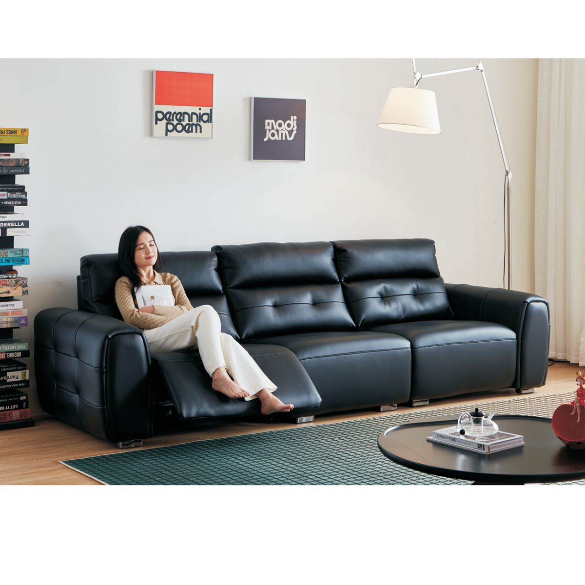 Full view of the black leather sofa in a living room setting