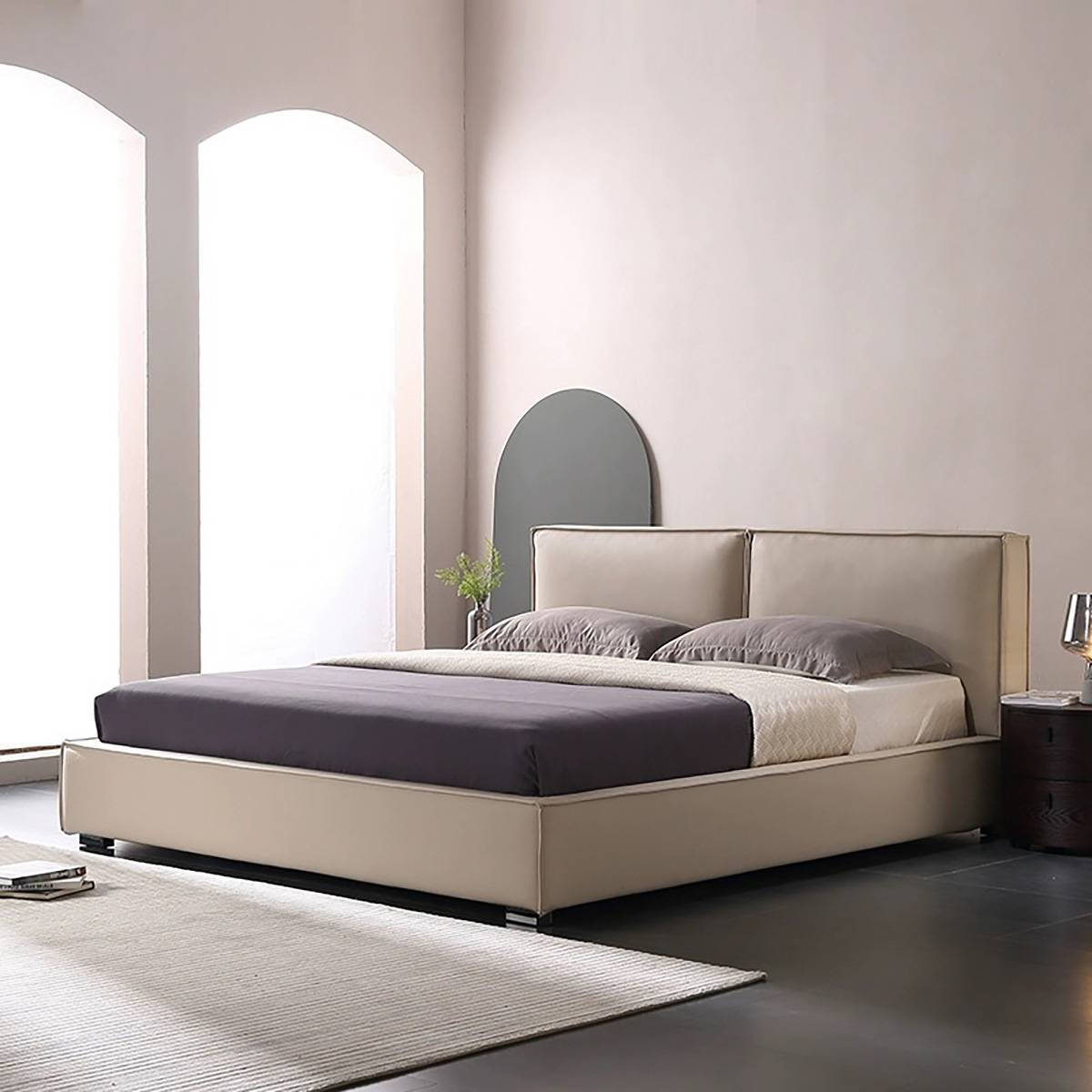 White upholstered bed with split headboard in a bright bedroom setting