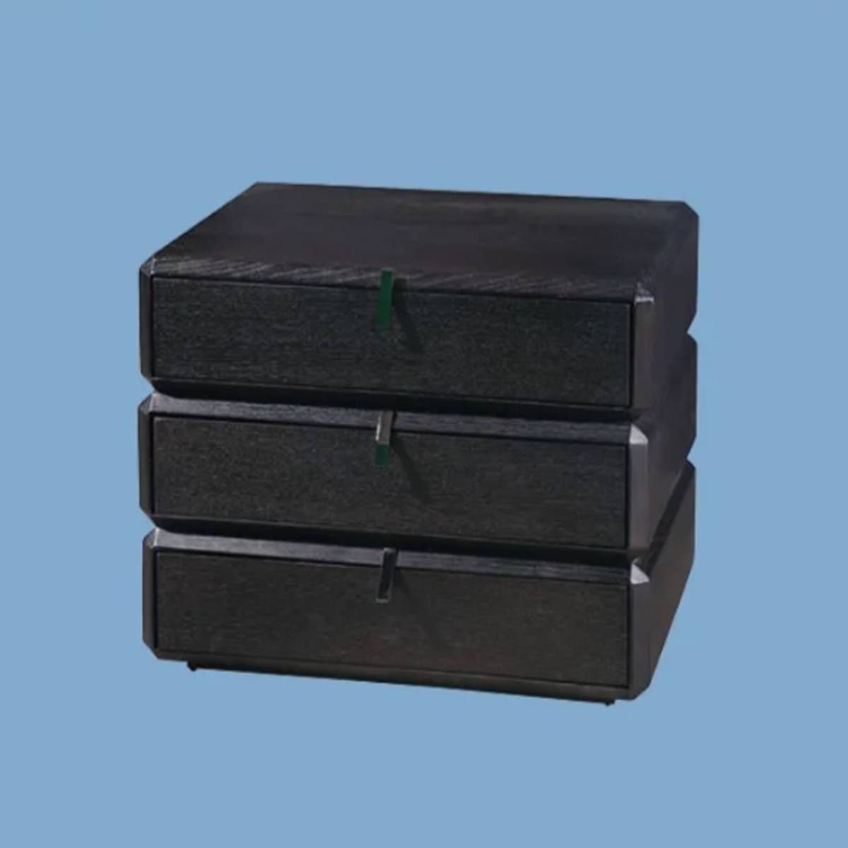 Angled view of black bedside cabinet against blue background
