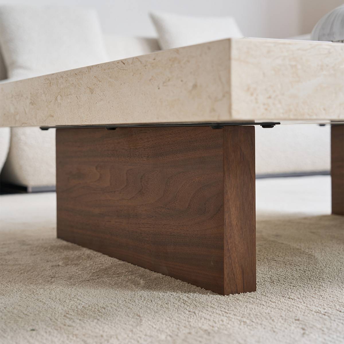 Close-up detail of the dark wood base and stone connection