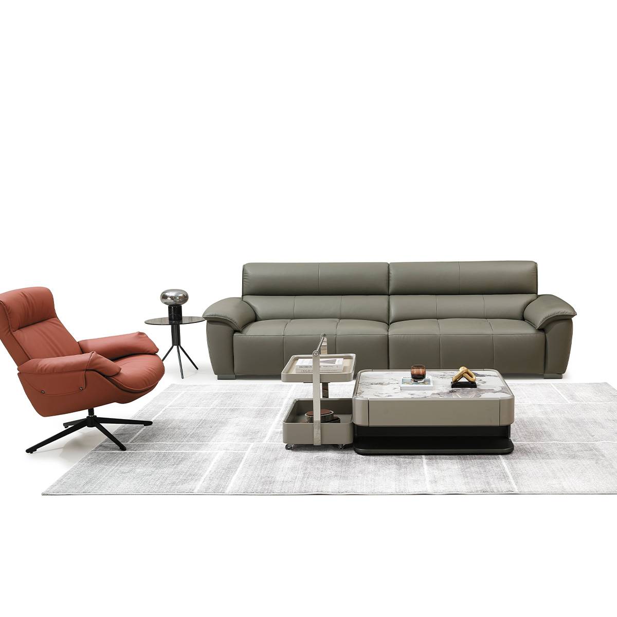 Front view of the sofa with a matching coffee table and a terracotta lounge chair on a white background.