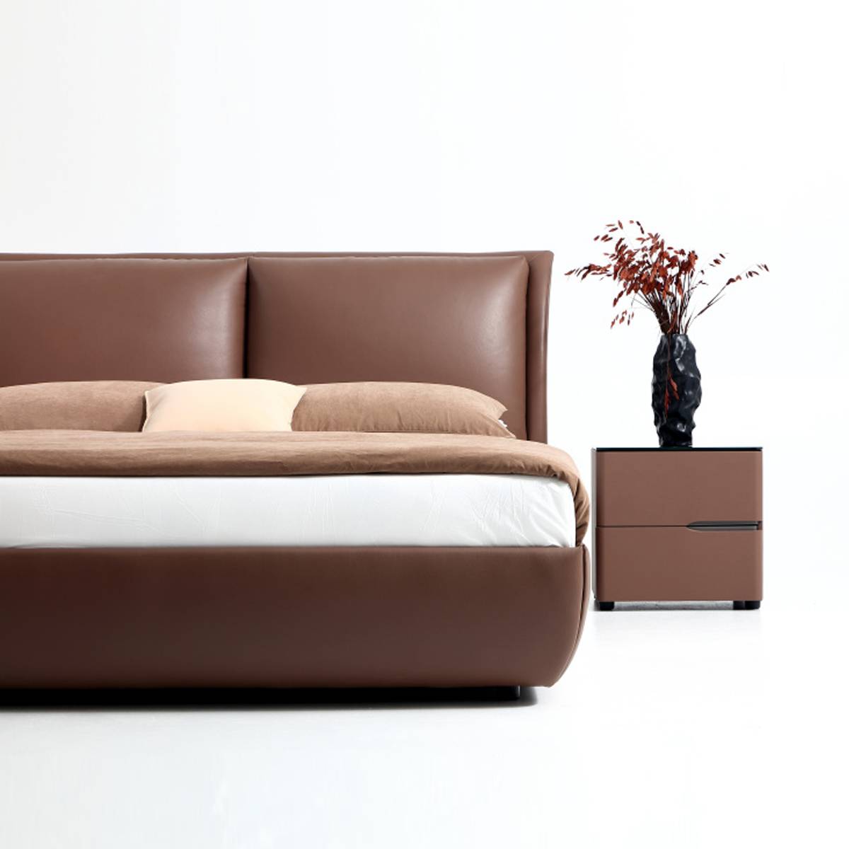Side view of brown leather bed frame with white mattress and brown bedding