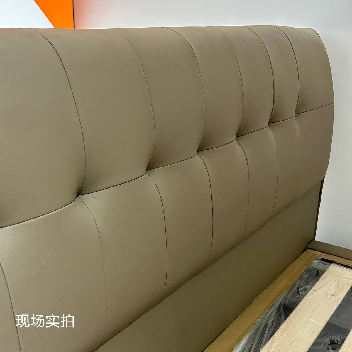 Close-up detail of the tufted leather headboard