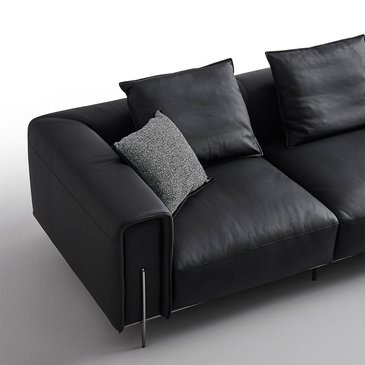 Close-up detail of the sofa armrest and leather texture
