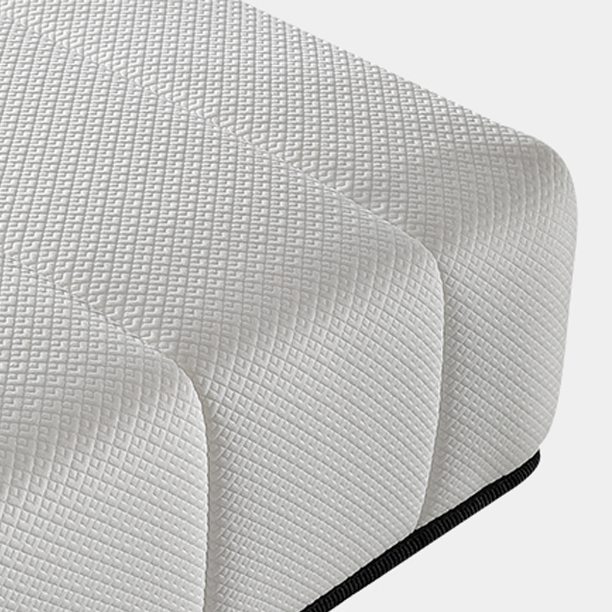 Detail shot of white quilted mattress surface texture