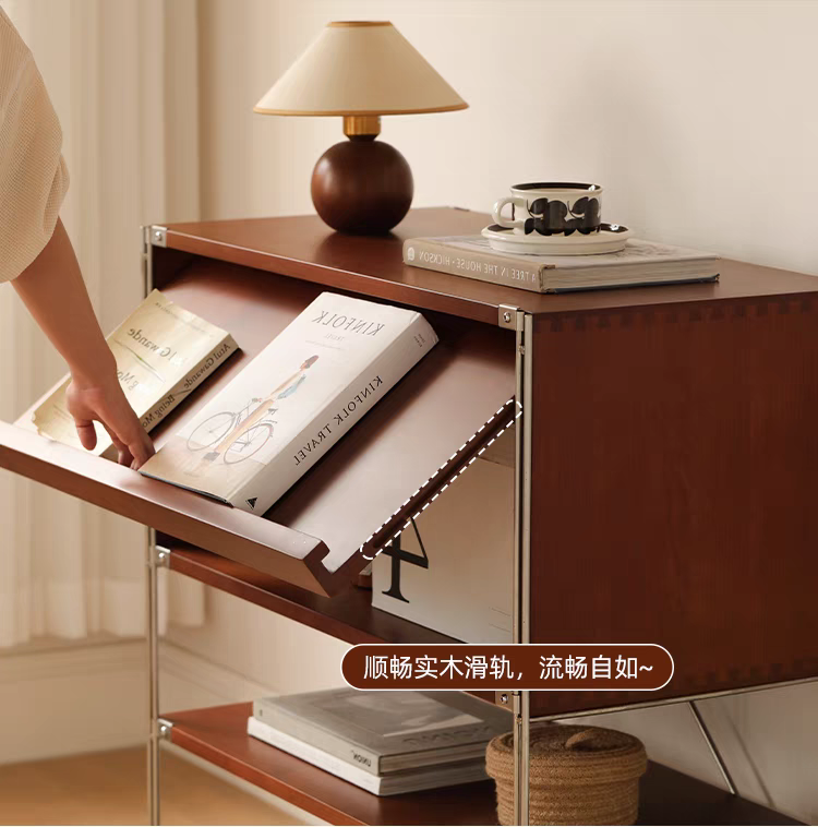 Close-up of the flip-door compartment showing smooth sliding rails and books inside