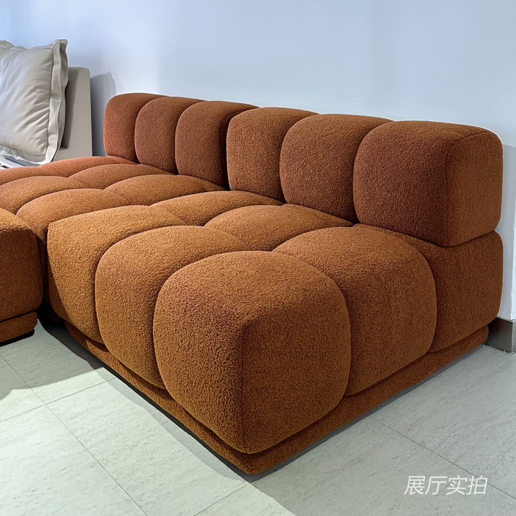 Close-up view of the brown tufted modular sofa cushions