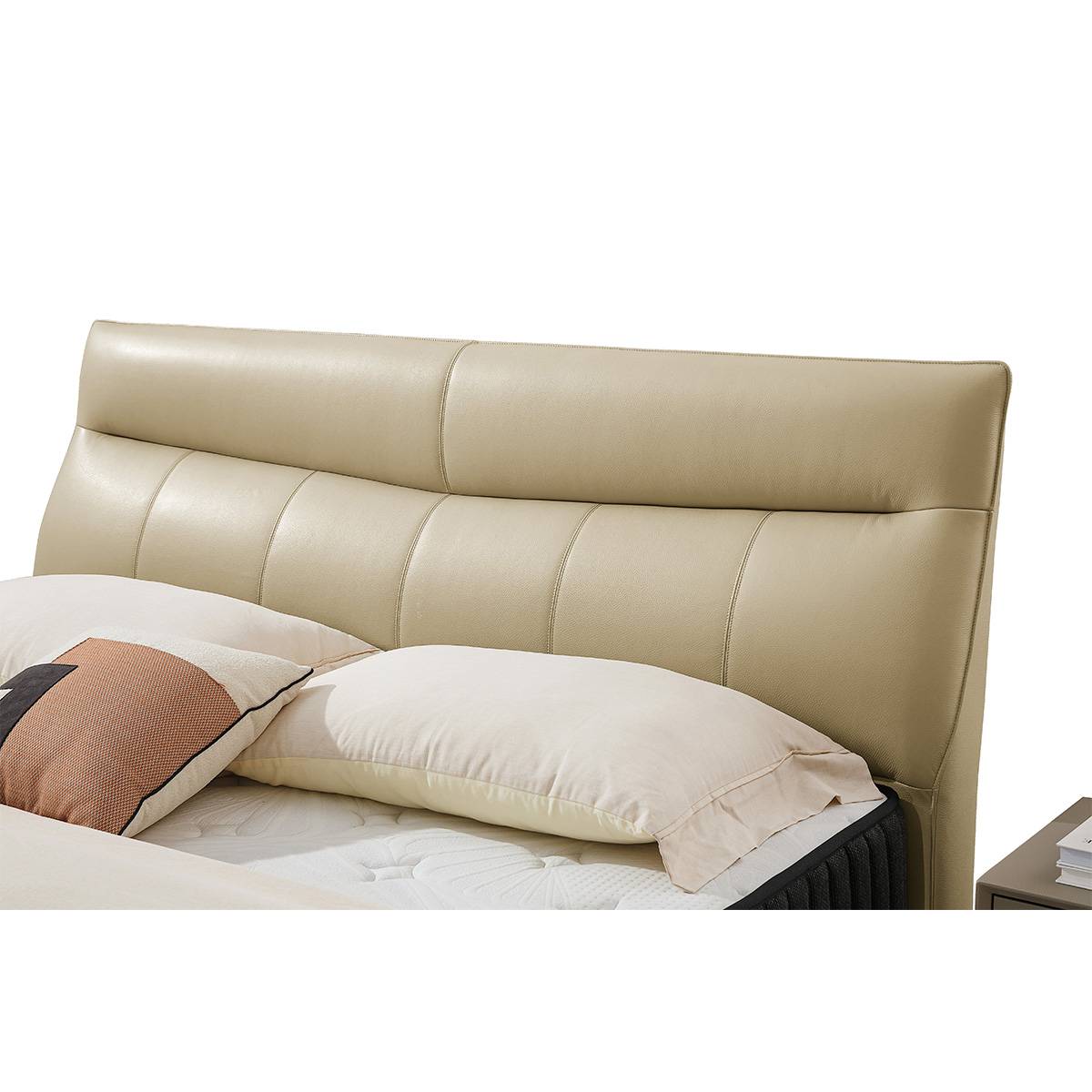 Front view of the beige leather bed with black mattress and side tables