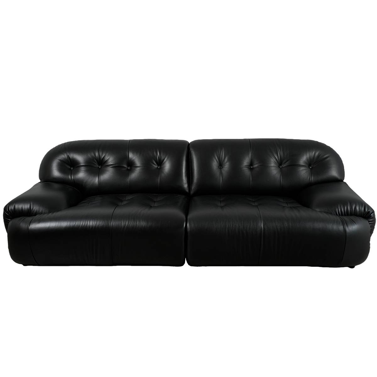 Side angle view of black tufted leather sofa