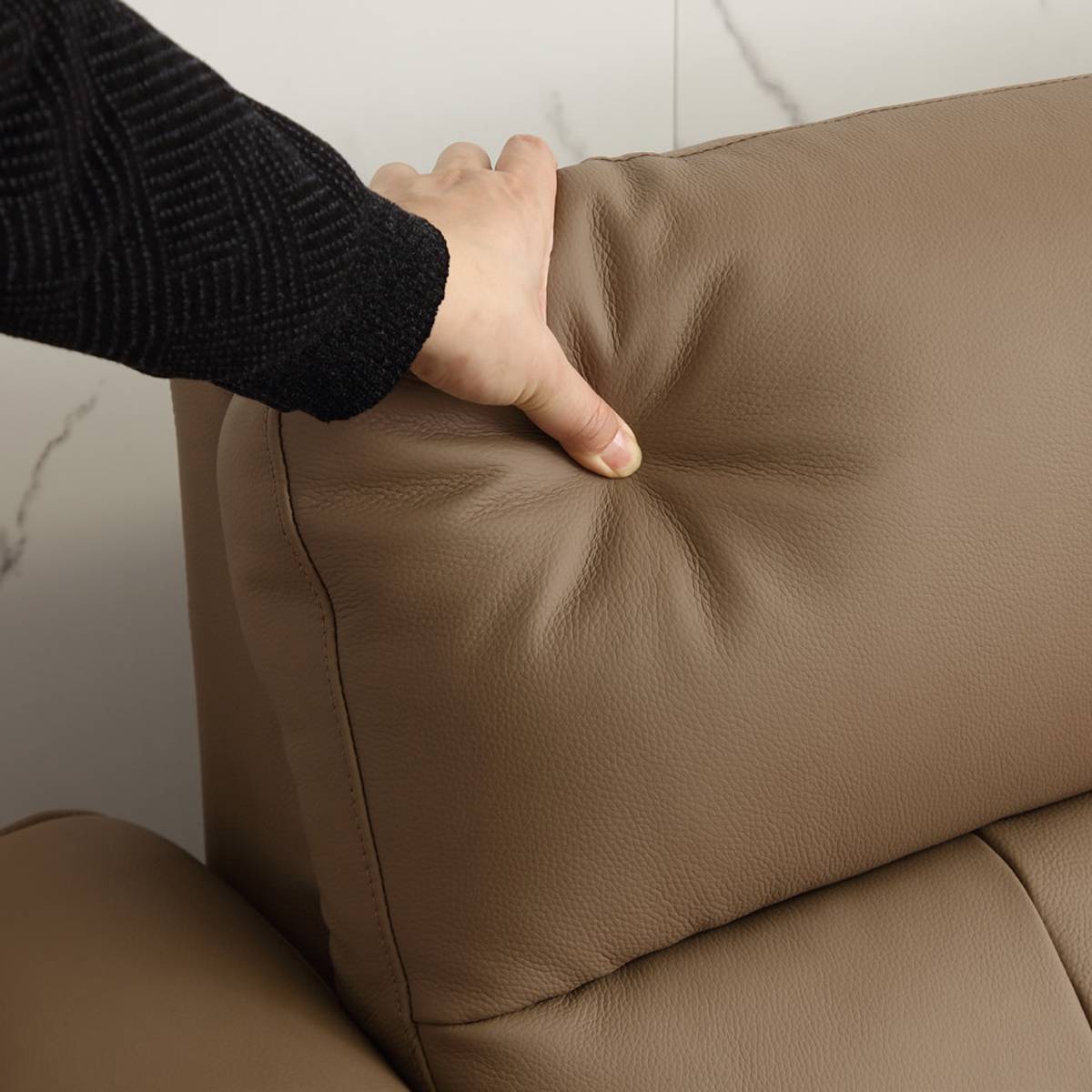 Close-up of the sofa seat cushion showing the leather texture and stitching details.