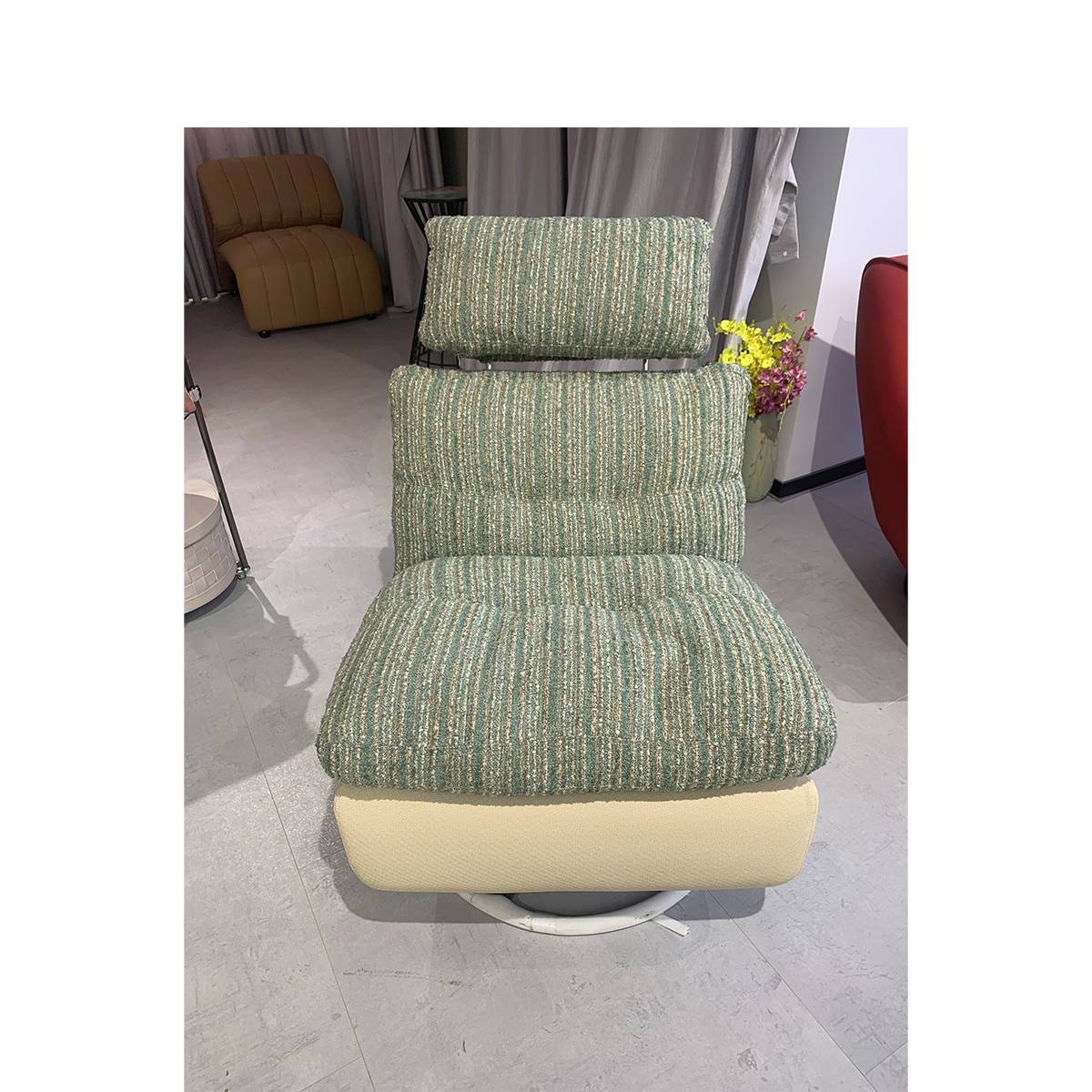 Close-up view of the green textured leisure chair showing the fabric detail and base